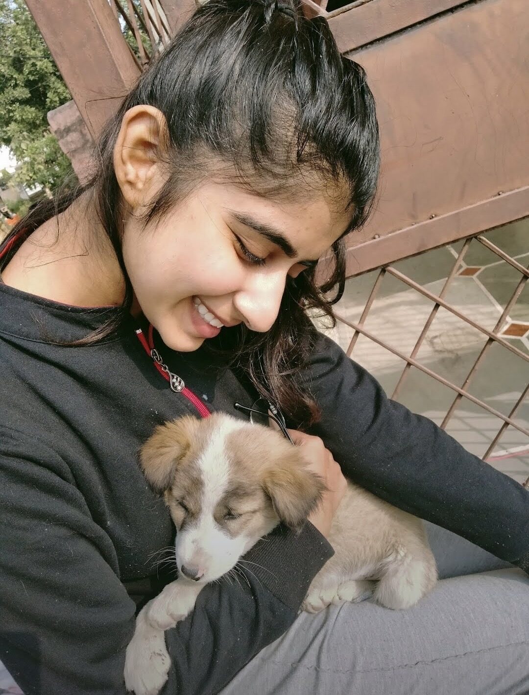 Suhani holding a rescued puppy